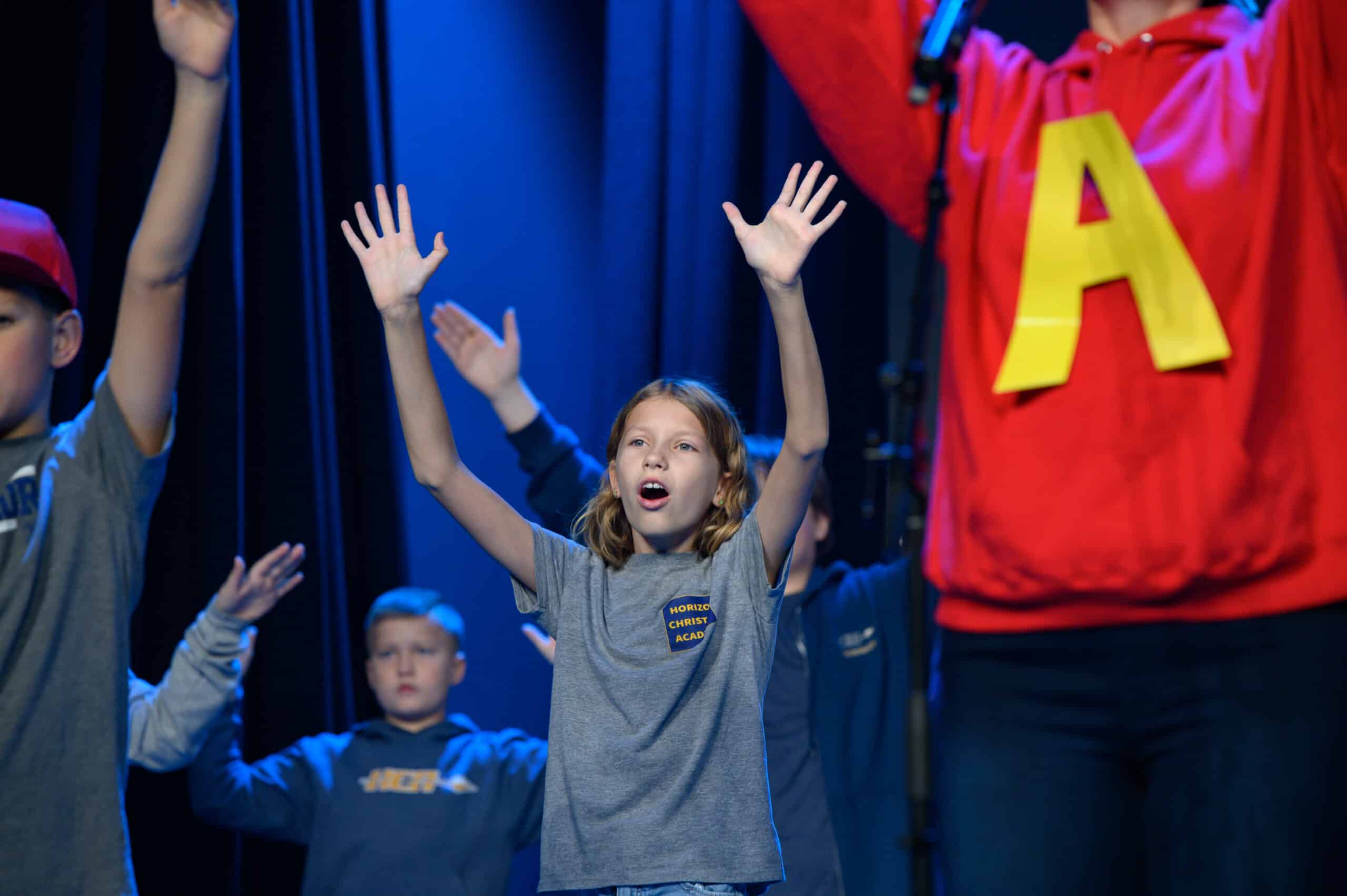 young girl on stage singing