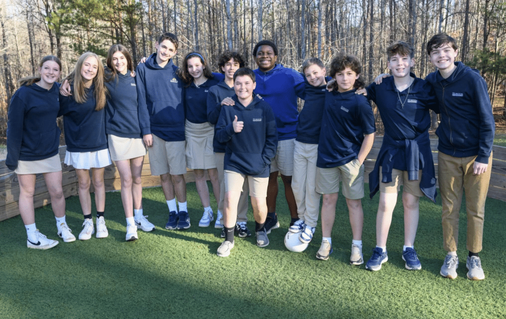 middle school students in uniform smiling at camera