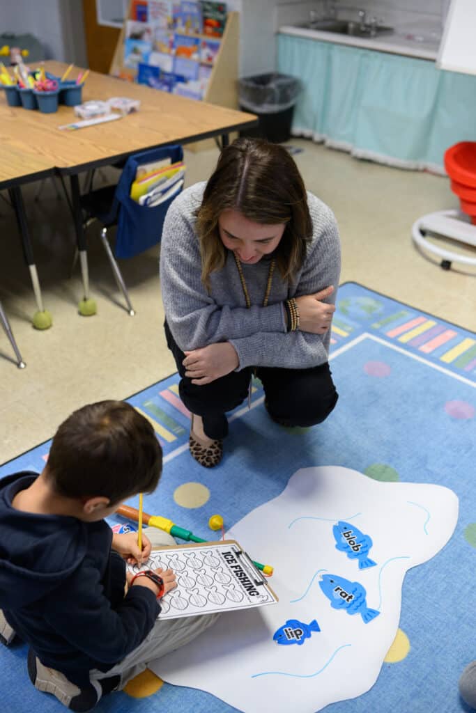 HCA elementary teacher with student doing vocabulary activity