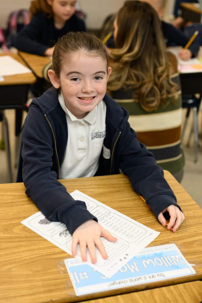 HCA elementary student at desk