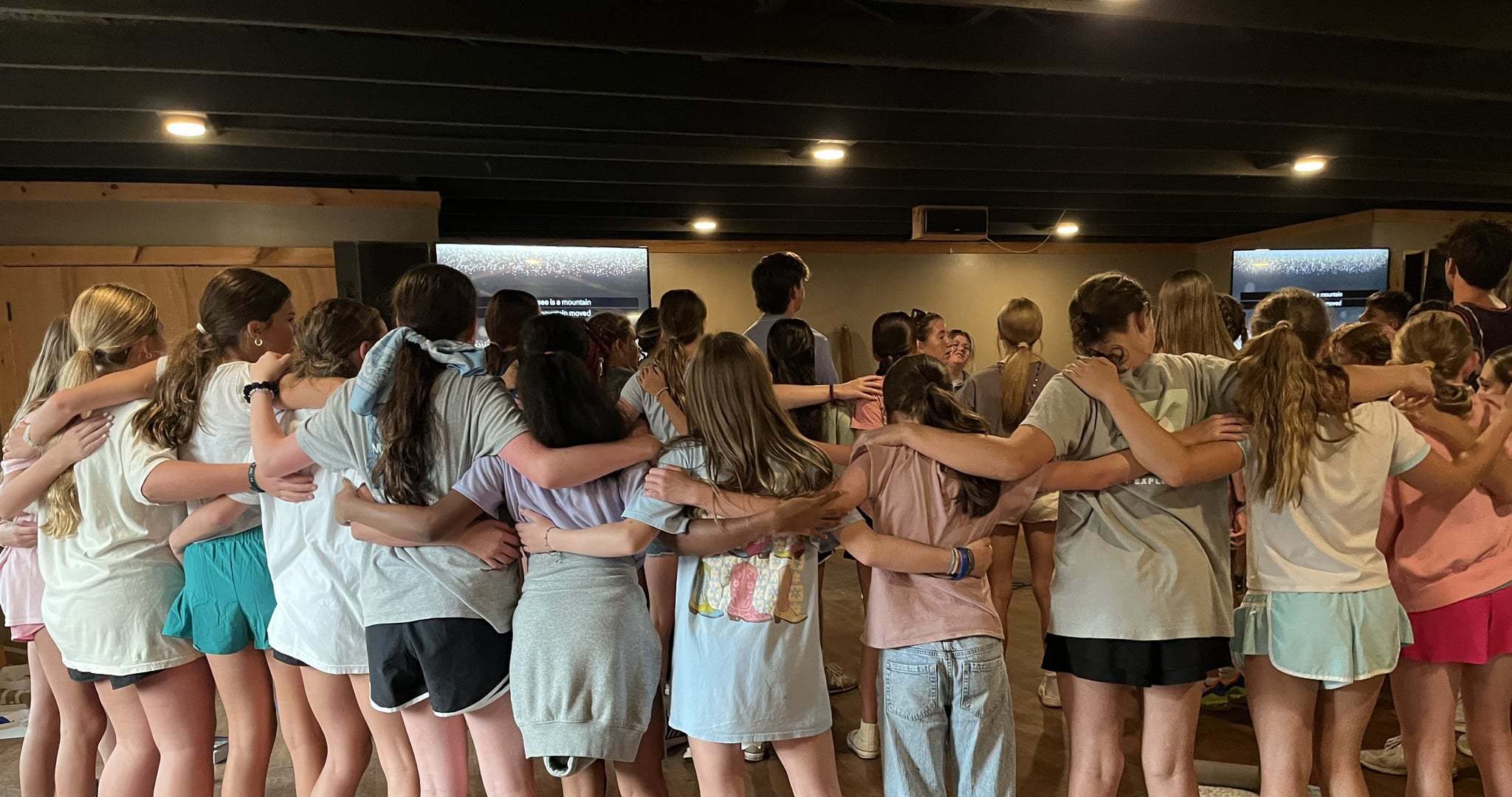 HCA students view with arms around each other, viewed from back