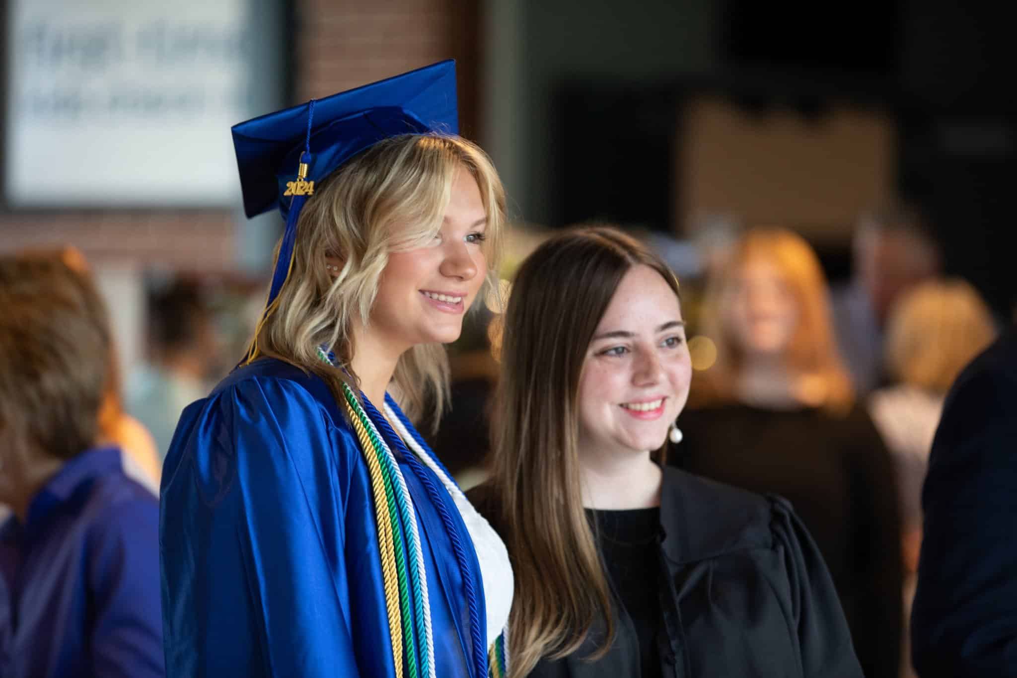HCA graduates smiling in cap and gown
